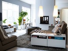 a living room filled with furniture and lots of windows