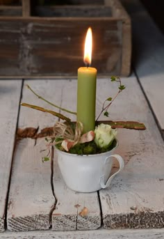 a candle that is sitting in a cup