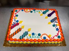 a birthday cake with candles and decorations on it