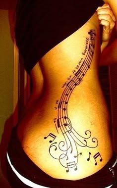 the back of a woman's stomach with musical notes on it