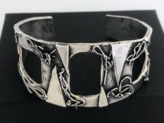 "Artisan Hand Made Sterling Silver Brutalist Cutout Cuff. Unique mix of polished and oxidized sterling silver accented with geometric and free form patterns. Lightly cleaned ready to wear. Will Fit Wrists Up To 6 3/4\" Markings: Unmarked, Acid tested and sterling silver. Measurements: Approx 6 3/4 inch total inside circumference including wrist opening, 2 3/8 inch inside diameter, 1 1/8 inch wrist opening and 1 3/4\" wide at front center. Total Weight: 40.5 grams Condition: Good Vintage Conditio Modern Oxidized Finish Cuff Bracelet As A Gift, Modern Cuff Bracelet With Oxidized Finish As Gift, Modern Oxidized Finish Cuff Bracelet, Modern Oxidized Cuff Bracelet Bangle, Modern Oxidized Finish Cuff Bracelet Bangle, Modern Silver Cuff Bracelet With Oxidized Finish, Modern Oxidized Finish Cuff Bangle Bracelet, Unique Oxidized Finish Cuff Bangle, Unique Oxidized Cuff Bracelet Bangle