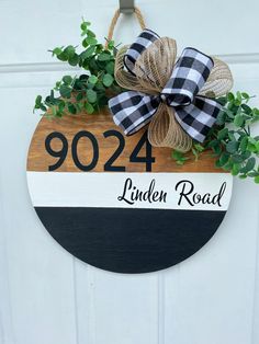 a door hanger with a wooden sign that says,'902 linden road '