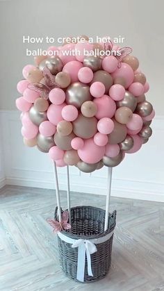 a basket filled with balloons in the shape of a tree on top of a wooden floor