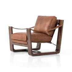 a brown leather chair sitting on top of a white floor next to a wooden frame