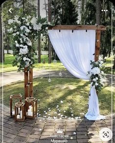 an outdoor wedding setup with white flowers and greenery