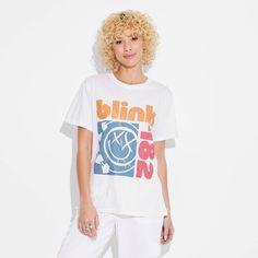 The Women's Blink 182 Short Sleeve Graphic T-Shirt in white is ideal for music lovers and fashion enthusiasts alike. This t-shirt features a graphic design of Blink 182’s iconic band logo for an added rock 'n’ roll flair to your ensemble. It is crafted from lightweight fabric for a comfortable and breathable feel. Whether you're hitting the streets or chilling with friends, the women's Blink 182 short sleeve graphic t-shirt in white is sure to make a statement. 90s Style White Graphic Print T-shirt, White Hip Hop T-shirt For Concert, Trendy Band Logo T-shirt For Summer, Trendy Band Logo T-shirt In Relaxed Fit, Trendy Relaxed Fit T-shirt With Band Logo, Spring Band Logo Graphic Tee, White Urban T-shirt For Concert, Urban White T-shirt For Concerts, Urban Style White T-shirt For Concert