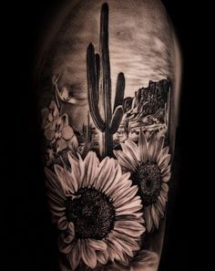 a black and white photo of a cactus with sunflowers