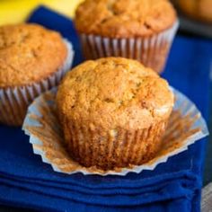 three muffins sitting on top of blue napkins