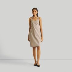 Unveil timeless elegance with our 'Fitted Knee Length Dress,' a stunning organic cotton outfit that radiates sophistication while embracing eco-conscious fashion. The dress has an elasticated back and side zipper for added convenience. Styled with a tie at the back and an optional belt, this dress offers styling versatility - tie the belt in the front or back. Designed for functionality, it features practical pockets on both sides. Elevate your wardrobe with this eco-friendly number, perfect for evening outings or daytime affairs. Front Twist Dress, Fitted Knee Length Dress, Strappy Mini Dress, Cotton Outfit, Twisted Dress, Tent Dress, Bandeau Dress, Conscious Fashion, Straight Dress