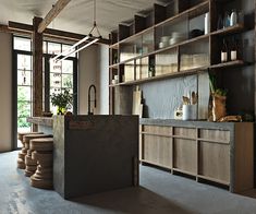 a kitchen with lots of shelves and counter space next to an open doored window