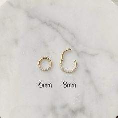 "14k Solid gold Daith or Septum Ring Clicker Features: Sold as a Single - ONE Clicker Material - 14k Solid gold and High Quality Cubic Zirconia Size: 6mm, 8mm High Polished Coming with a Gift Box WE CAREFULLY INSPECT ALL OF MY PIECES BEFORE THEY LEAVE THE STUDIO. IF EVER AN ITEM ARRIVES DAMAGED, IT MUST BE REPORTED TO ME IMMEDIATELY- WITHIN 24HRS AFTER DELIVERY. We take all responsibility of BROKEN ITEMS in 5 DAYS AFTER DELIVERY. * Return or Exchange in 14k Solid Gold * 1 - Customer MUST contact The Studio, Septum Ring, Solid Gold, Cubic Zirconia, Gift Box, Hoop Earrings, Stud Earrings, Ring, High Quality