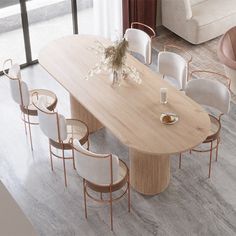 a dining table with chairs around it and a vase on the table next to it