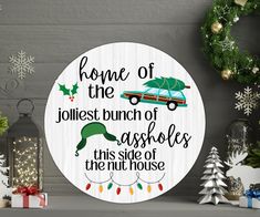 a round wooden sign that says home of the jolliest bunch of assorteds this side of the christmas tree