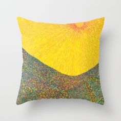 a yellow and green pillow with an abstract painting on it