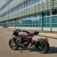 the motorcycle is parked on the side of the road by the building in front of it