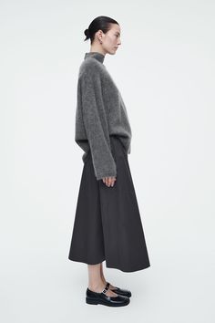 ELASTICATED MIDI SKIRT - BLACK - Skirts - COS Fall Midi Skirt With Side Pockets, Winter Workwear Bottoms In Midi Length, Midi Voluminous Skirt For Workwear, Winter Workwear Cotton Skirt, Workwear Relaxed Fit Flared Skirt, Relaxed Fit Flared Skirt For Work, Relaxed Fit Skirt For Workwear In Fall, Black Relaxed Fit Skirt For Work, Denim Suit