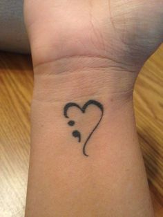 a small heart with a stethoscope tattoo on the wrist