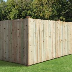 a wooden fence in the middle of some grass