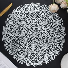 a white doily sitting on top of a black table