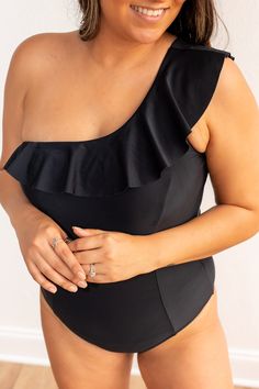 The standout feature of this swimsuit is the stylish ruffle detail, which adds a playful and feminine element to the overall design. The ruffle is strategically placed, enhancing the glamour of the one-shoulder silhouette. The combination of the sleek black color, the one-shoulder style, and the charming ruffle makes the Sophia Black One Shoulder One Piece a statement piece for those who appreciate both fashion and functionality in their swimwear.Fit: True To Size Material: 80% Nylon 20% Spandex Sophia Black, Beach Vacay, One Shoulder Swimsuit, Body Measurements, Black Color, One Shoulder, Sleek, Spandex, One Piece