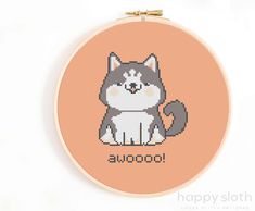 a cross stitch cat with the word swoo on it's face is sitting in front of an orange background