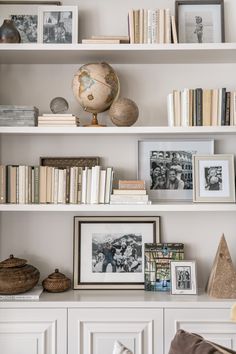 the bookshelves are filled with pictures and other decorative items, such as an ornament