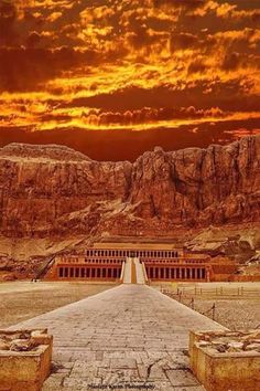 the entrance to an ancient city with mountains in the background