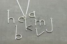 "Everybody needs a necklace with their first initial on it. If you don't have one, I can make it for you. It won't go out of style and its awesome for tshirt time or dressing up. The entire letter has been hand formed, cut, filed, soldered, hammered, and polished by me out of sterling silver. It is then put on a sterling ring and onto a sterling silver chain. Measurements: Small letters (such as m e s a c) are around 1/2\" and tall letters (such as t p k h j) are around 1\". *Last picture is an Kay Jewelry, Name Necklaces, Jewelry Photoshoot, Jewelry Photography, Diy Schmuck, Letter Necklace, Dainty Jewelry, Initial Necklace, Minimalist Jewelry