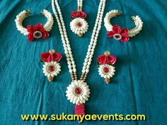 the necklaces and earrings are decorated with flowers