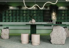 a green room with two large rocks and vases on the table in front of it