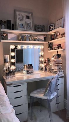 a white vanity with lights on it in a bedroom