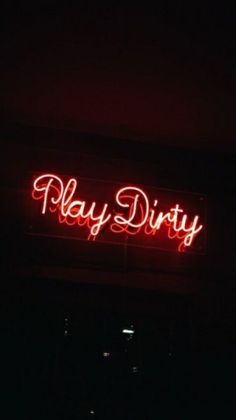 a red neon sign that says play dirty