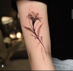 a woman's arm with a flower tattoo on the left side of her arm