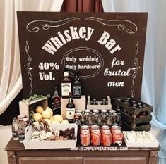 a table topped with lots of different types of food and drinks next to a sign that says whiskey bar