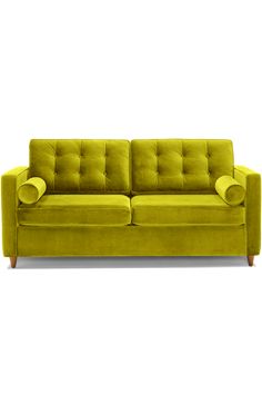 a green couch sitting on top of a white floor