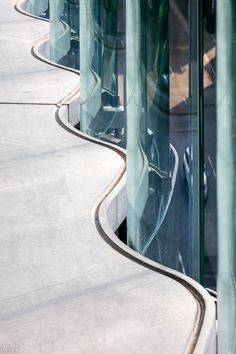 the curved walkway is lined with glass walls