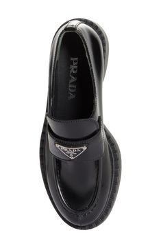 Prada's iconic triangular logo shines on a polished patent-leather loafer tastefully updated with a ridged sole and a welt resembling tiny chocolate bars. 1 1/2" (38mm) heel; 3/4" platform (size 8.5US/38.5EU) Leather upper and lining/rubber sole Made in Italy Women's Designer Shoes Luxury Patent Leather Loafers With Branded Insole, Designer Patent Leather Loafers For Work, Luxury Patent Leather Pointed Toe Loafers, Designer Patent Leather Loafers With Rubber Sole, Designer Patent Leather Pointed Toe Loafers, Business Leather Loafers With Glossy Finish, Glossy Leather Loafers For Business, Luxury Glossy Leather Loafers, Prada Loafers Women