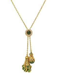 Designed as a negligee style necklace comprised of cable link chain terminating with drops One is a fringe tassel, and the other a conical drop accented by scrolling c motif openwork Accented by jade cabochon fringe and caps ranging from 4.0 to 9.0 mm round Translucent medium mossy green in color, and each bezel set  Cinched with an adjustable round-shaped slide station  Centering a 6.0 mm round jade cabochon - well-matched Bezel set with halo surround of 2.0 mm round seed pearls Cream to gray in body color with moderate iridescence  Reverse is decorated with scrolling filigree and granulation Completed by barrel clasp closure Tested as 14 karat gold Circa: 1890s Slide Station Measures: 3/8 inch Conical Drop Measures: 3/8 x 3/4 inch Tassel Drop Measures: 1/2 x 1 inch Chain Length: 18 1/2 i Elegant Green Lariat Necklace, Elegant Green Dangle Drop Necklace, Elegant Green Jewelry With Tassels, Elegant Green Tassel Jewelry, Mossy Green, Victorian Gold, Pearl Cream, Body Color, Gold Chain Necklace