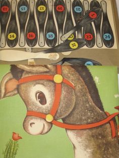 two children's books with pictures of donkeys and scissors