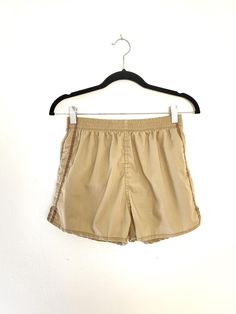 vintage unisex style gym shorts, lightweight cotton poly material, lined, elastic waist with drawstring, single back pocket best fits small/medium,  measurements:  waist 25" laid flat (stretches to approx 36") length 12", inseam 2.5" great gently pre-owned condition, very minor wear, see pics for detail For reference model is approx 5'9", Bust 34" Waist 25" Hip 37" Feel free to bundle with other items Items are pre-owned and may have small flaws due to age. Any major/noticeable flaws will be noted in description. Sporty Cotton Pajama Shorts For Vacation, Cotton Drawstring Pajama Shorts, Cotton Pajama Shorts With Drawstring, Casual Cotton Swim Trunks With Built-in Shorts, Basic Cotton Athletic Shorts For Summer, High-waisted Cotton Athletic Shorts With Drawstring, Sporty Cotton Swim Trunks Short Length, Relaxed Fit Cotton Athletic Shorts For Beach, Basic Athletic Shorts With Elastic Waistband