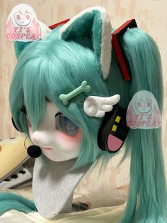 a doll with green hair and ears on top of a table