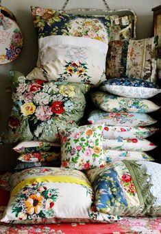 many pillows are stacked on top of each other