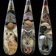 three surfboards with different designs and animals painted on the bottom one has an owl, two are owls