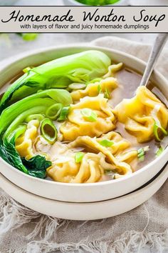 a white bowl filled with noodles and green peppers on top of a cloth covered table