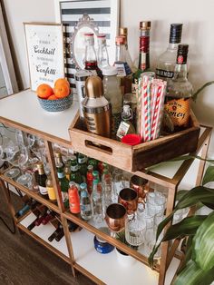 a bar cart filled with liquor bottles and glasses