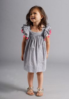 Grey child's dress with bright pink pom-poms Nellystella Dress, Madison Grace, Kids Accessories Fashion, Kids Wear Girls, Kids Frocks, Dress Indian, Indian Summer