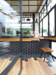 a blurry photo of a restaurant counter with chairs and tables in front of it