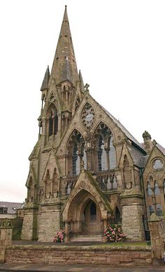 an old stone church with a clock tower