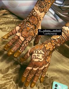 two hands with henna tattoos on them