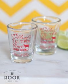 two shot glasses sitting on top of a table